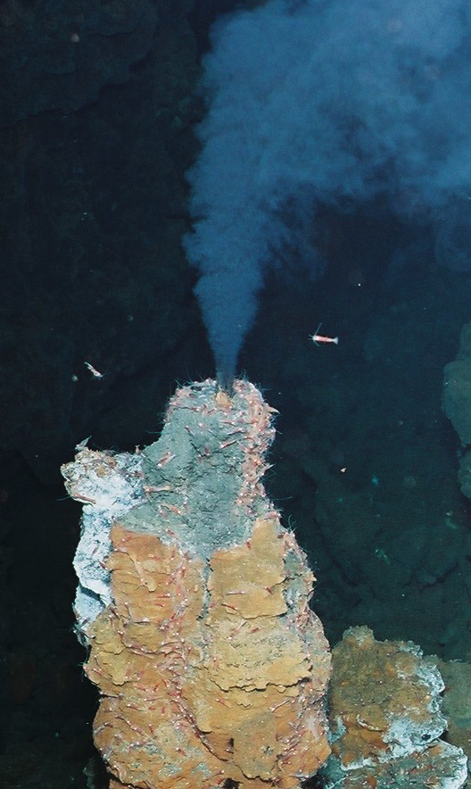 An orange rocky shape in dark blue water
